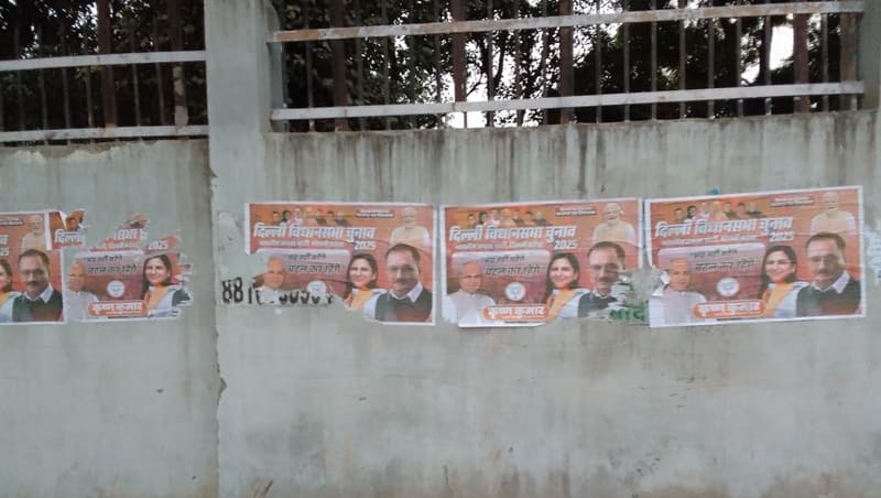 Political outfits defacing public property by pasting their posters on walls before the Delhi Assembly Election 2025. Photo: Rakesh Raman / RMN News Service